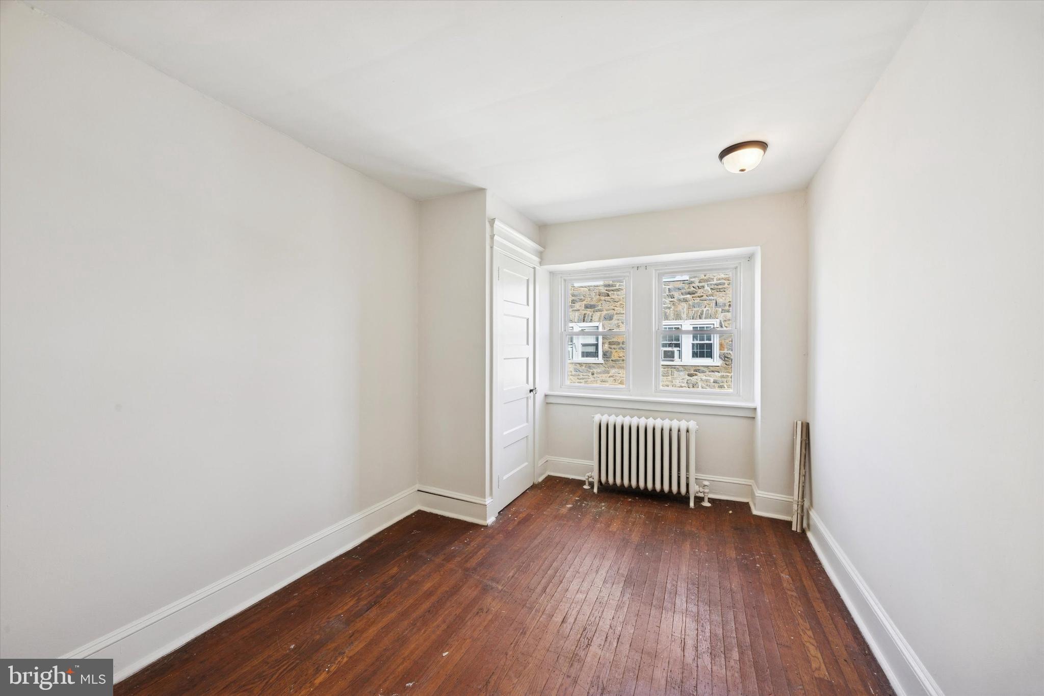 46 Copley Road Upper Darby, PA 19082 - Photo 10 of 21 an empty room with wooden floor and window