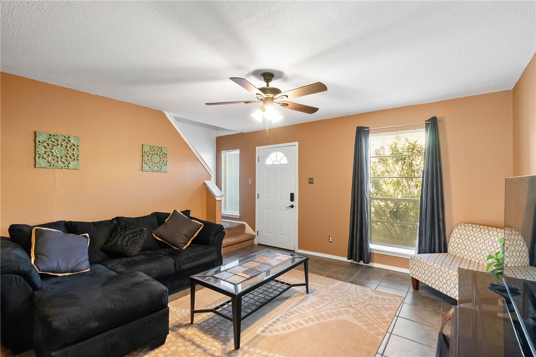 6702 Everhart Road, Unit H102 Corpus Christi, TX 78413 - Photo 3 of 15 a living room with furniture and a large window