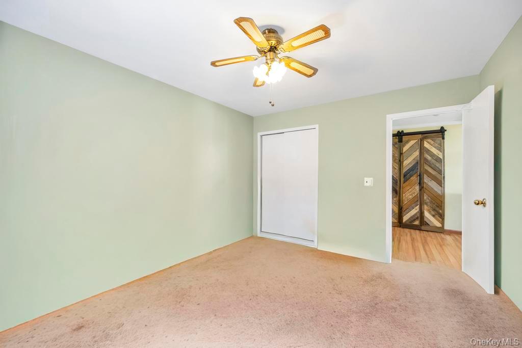 13 Mallard Path Coram, NY 11727 - Photo 19 of 39 an empty room and a ceiling fan in closet