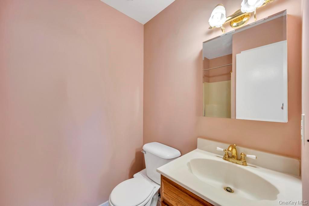 13 Mallard Path Coram, NY 11727 - Photo 20 of 39 a bathroom with a sink mirror and toilet