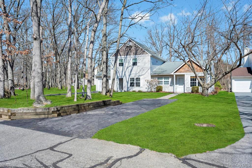 13 Mallard Path Coram, NY 11727 - Photo 2 of 39 a front view of a house with a garden