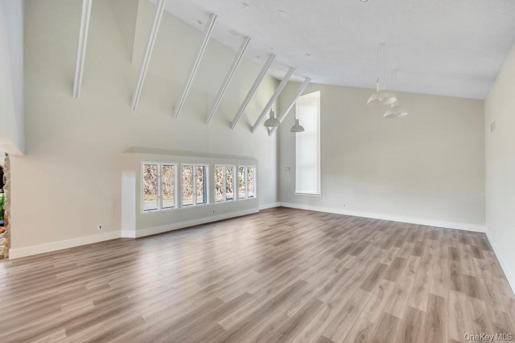 13 Mallard Path Coram, NY 11727 - Photo 33 of 39 a view of an empty room with wooden floor and a window