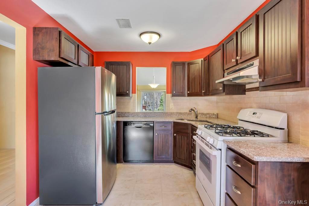 13 Mallard Path Coram, NY 11727 - Photo 7 of 39 a kitchen with stainless steel appliances granite countertop a refrigerator and a stove