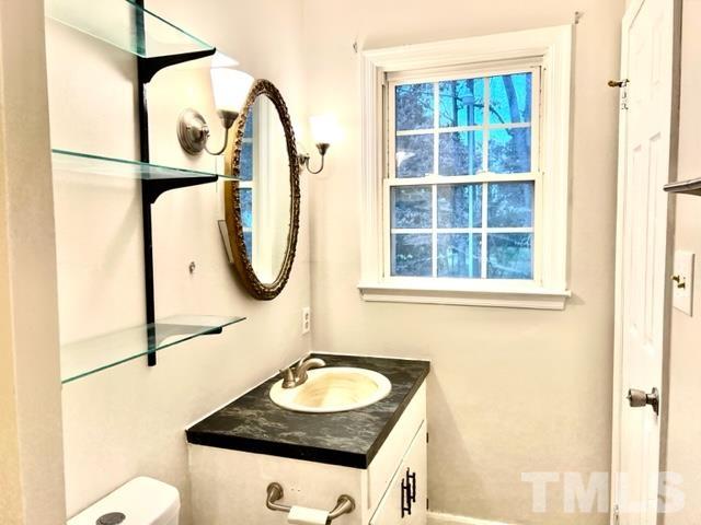 115 Kerr Lake Club Road Henderson, NC 27537 - Photo 14 of 20 a bathroom with a granite countertop sink and a mirror