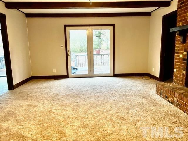 115 Kerr Lake Club Road Henderson, NC 27537 - Photo 4 of 20 a view of an empty room with glass door