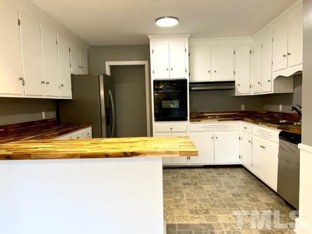 115 Kerr Lake Club Road Henderson, NC 27537 - Photo 6 of 20 a kitchen with stainless steel appliances granite countertop a sink and cabinets