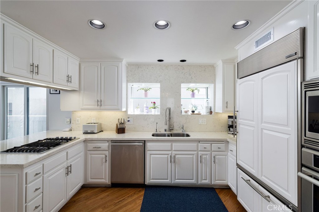 90 Rivo Alto Canal Long Beach, CA 90803 - Photo 16 of 52 a kitchen with white cabinets and white appliances