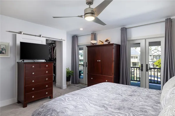 a bedroom with a bed and a mirror