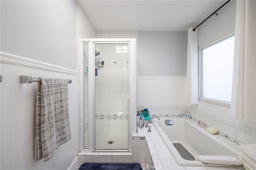 90 Rivo Alto Canal Long Beach, CA 90803 - Photo 29 of 52 a bathroom with a tub sink a window and a shower