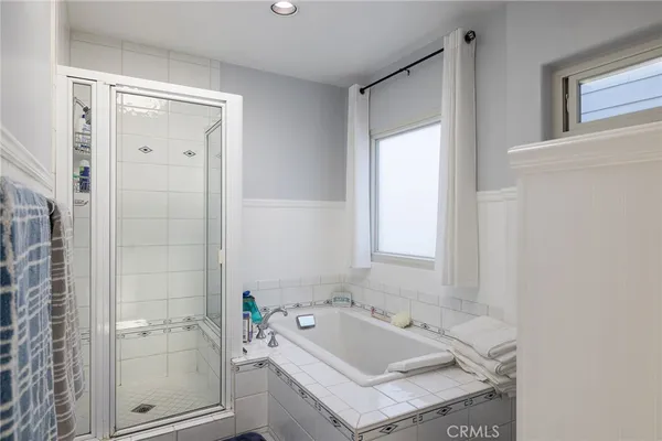 a view with double vanity sink a mirror a lamp and vanity
