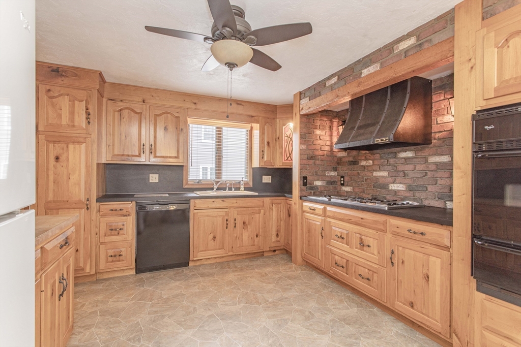 71 Vallaro Road Boston, MA 02136 - Photo 11 of 37 a kitchen with granite countertop a refrigerator stove top oven and sink