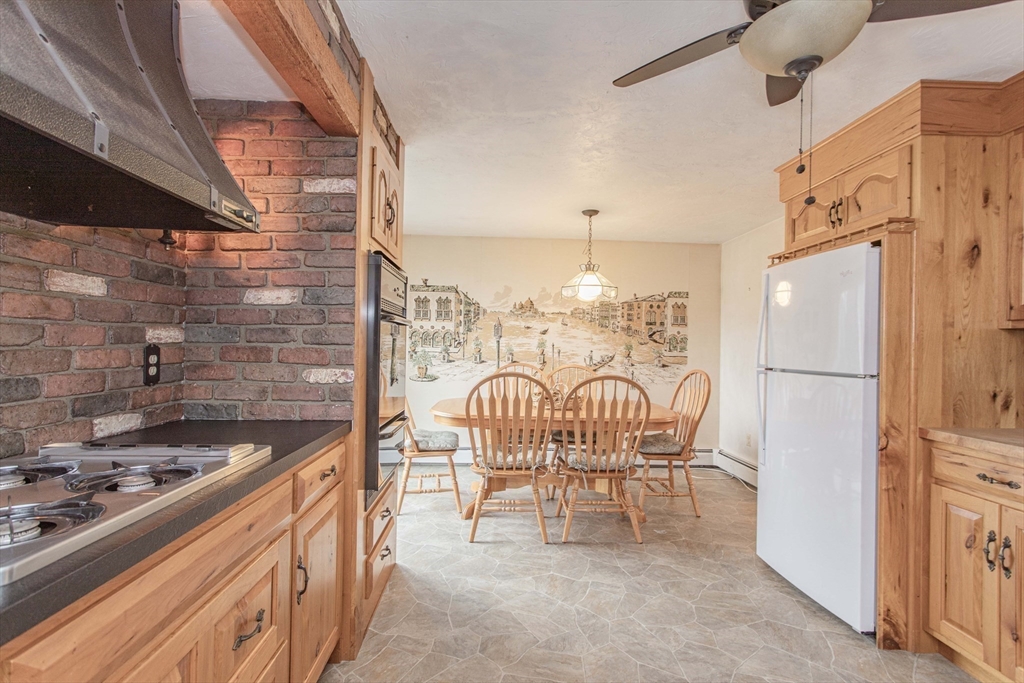 71 Vallaro Road Boston, MA 02136 - Photo 12 of 37 a kitchen with a table chairs stove and refrigerator