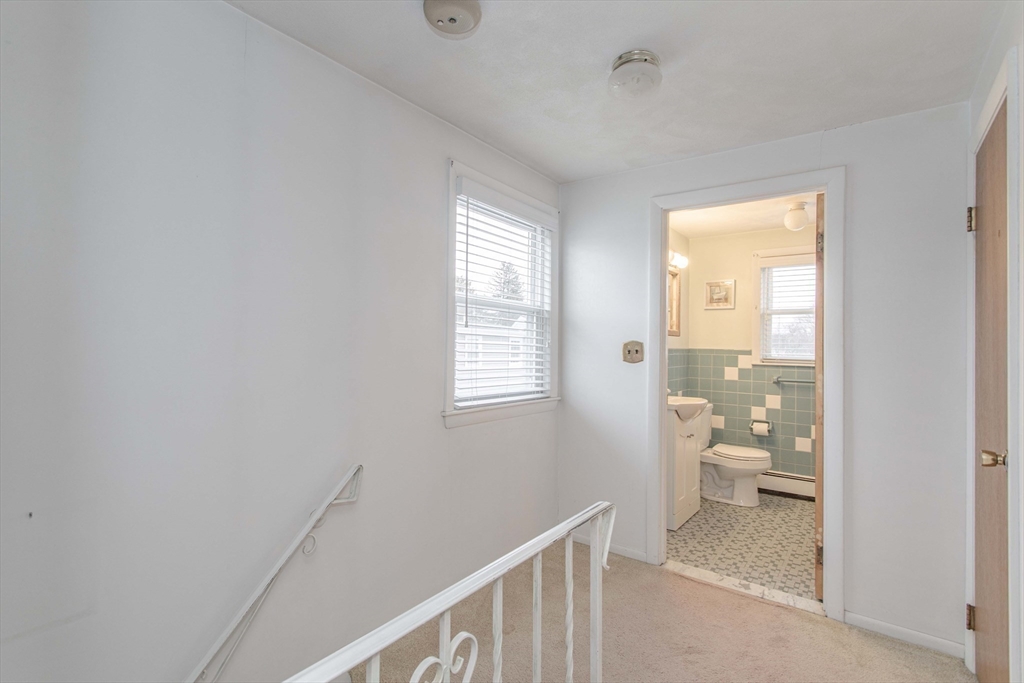 71 Vallaro Road Boston, MA 02136 - Photo 16 of 37 a view of a hallway with bathroom and wooden floor