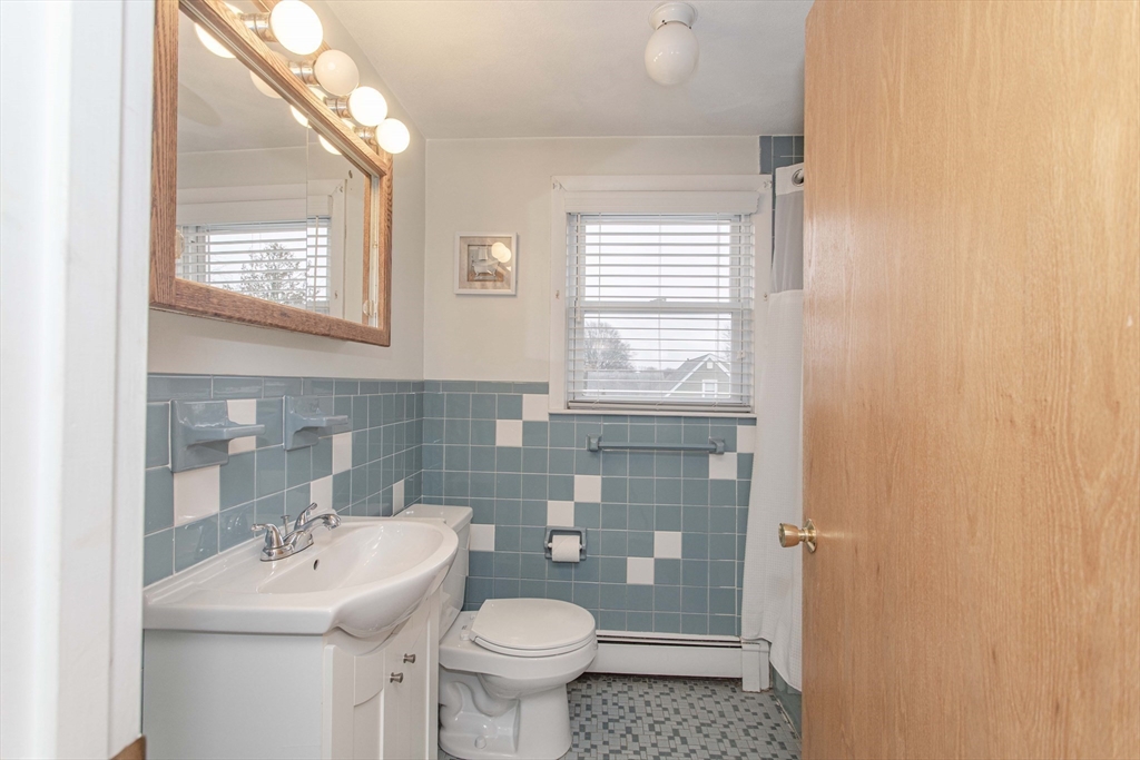 71 Vallaro Road Boston, MA 02136 - Photo 17 of 37 a bathroom with a sink toilet and mirror