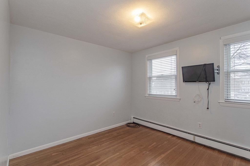 71 Vallaro Road Boston, MA 02136 - Photo 20 of 37 an empty room with wooden floor and windows