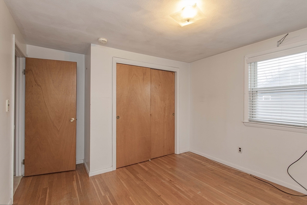 71 Vallaro Road Boston, MA 02136 - Photo 25 of 37 a view of an empty room with wooden floor and a window