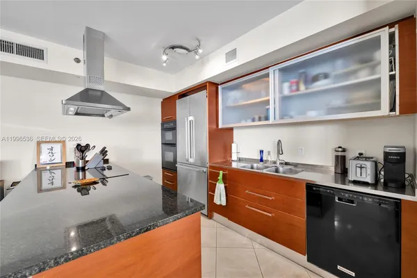 a kitchen with stainless steel appliances granite countertop a sink and stove