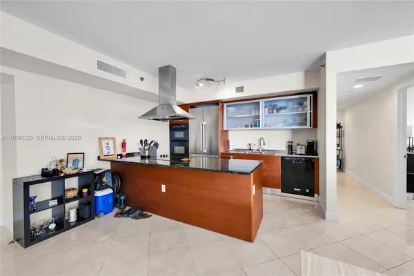 a living room with furniture and a kitchen view