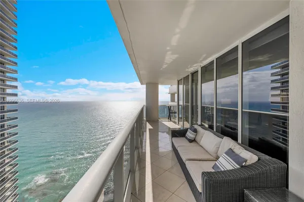 a balcony with wooden floor and furniture
