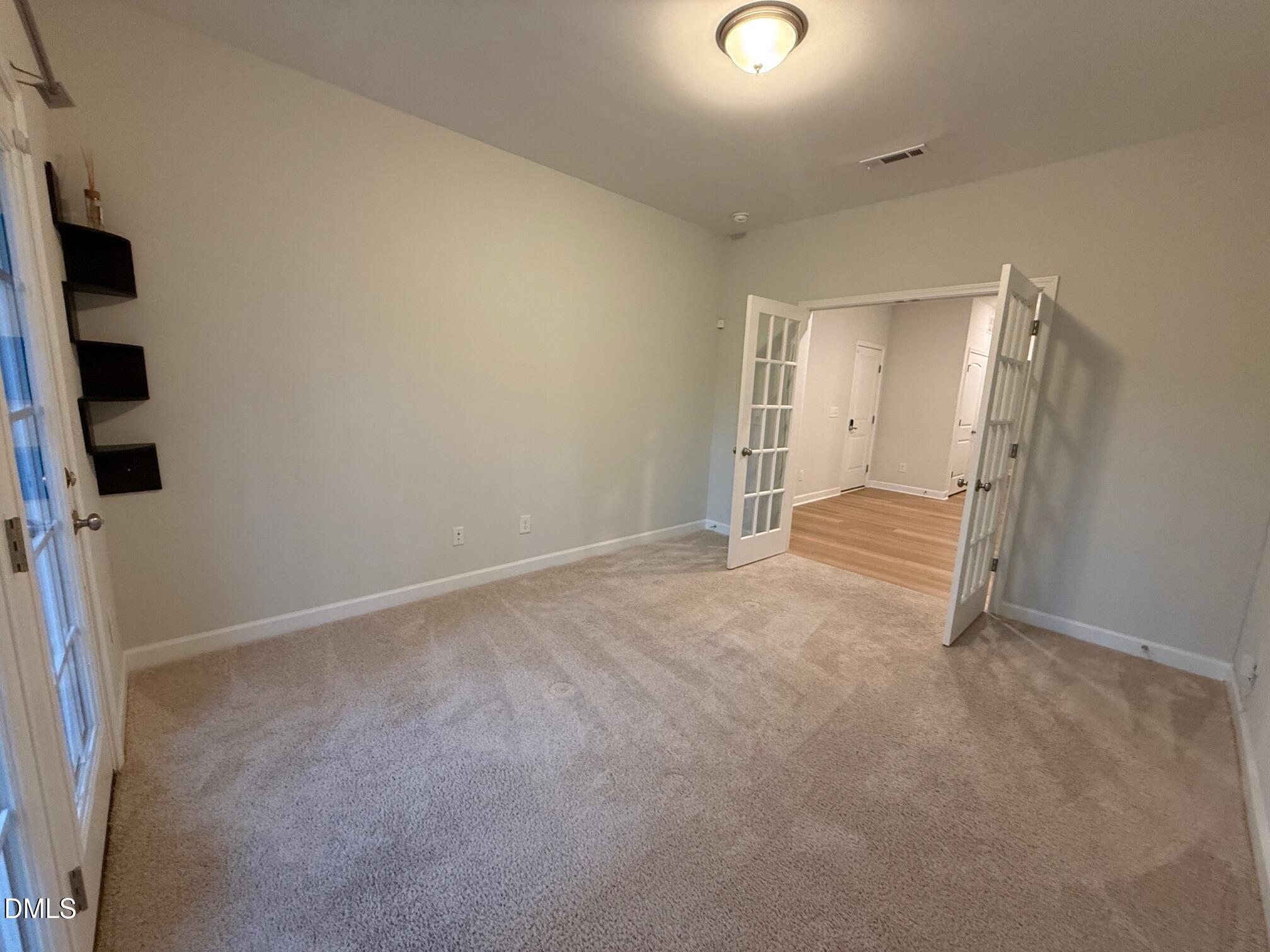 230 George Pine Way Knightdale, NC 27545 - Photo 11 of 31 an empty room with closet and windows
