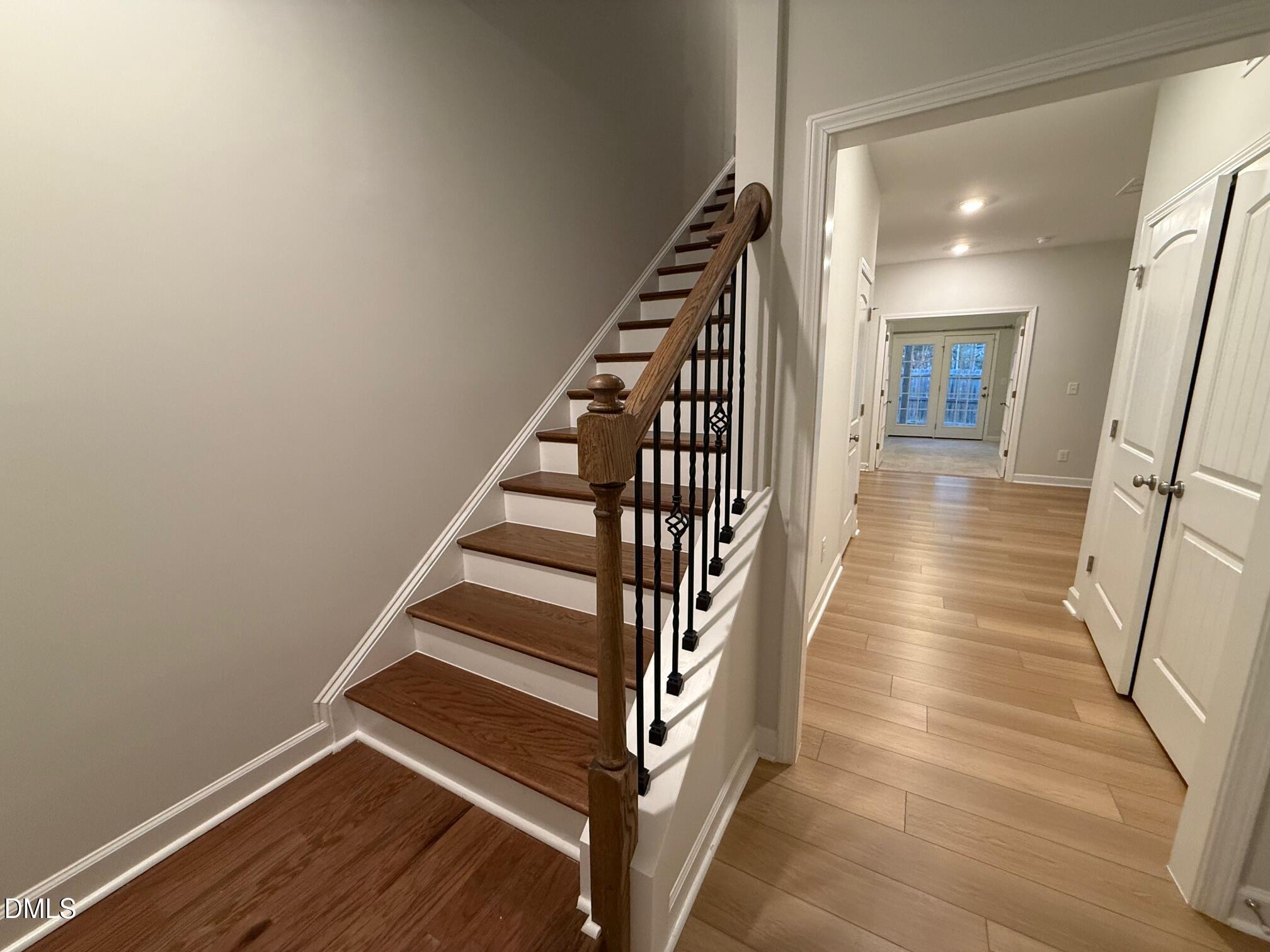 230 George Pine Way Knightdale, NC 27545 - Photo 17 of 31 a view of a hallway with wooden floor and staircase