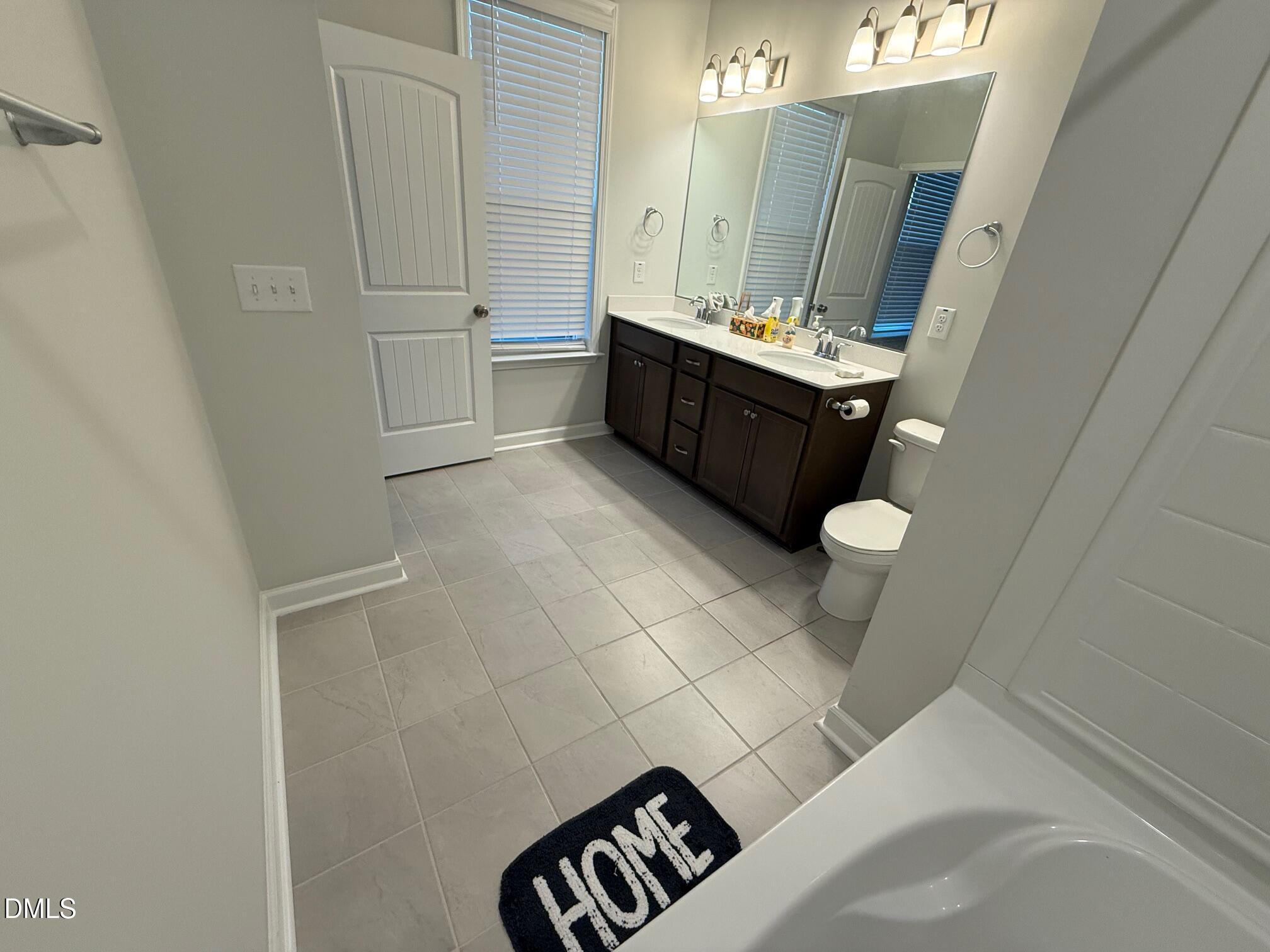 230 George Pine Way Knightdale, NC 27545 - Photo 19 of 31 a bathroom with a sink a toilet and mirror