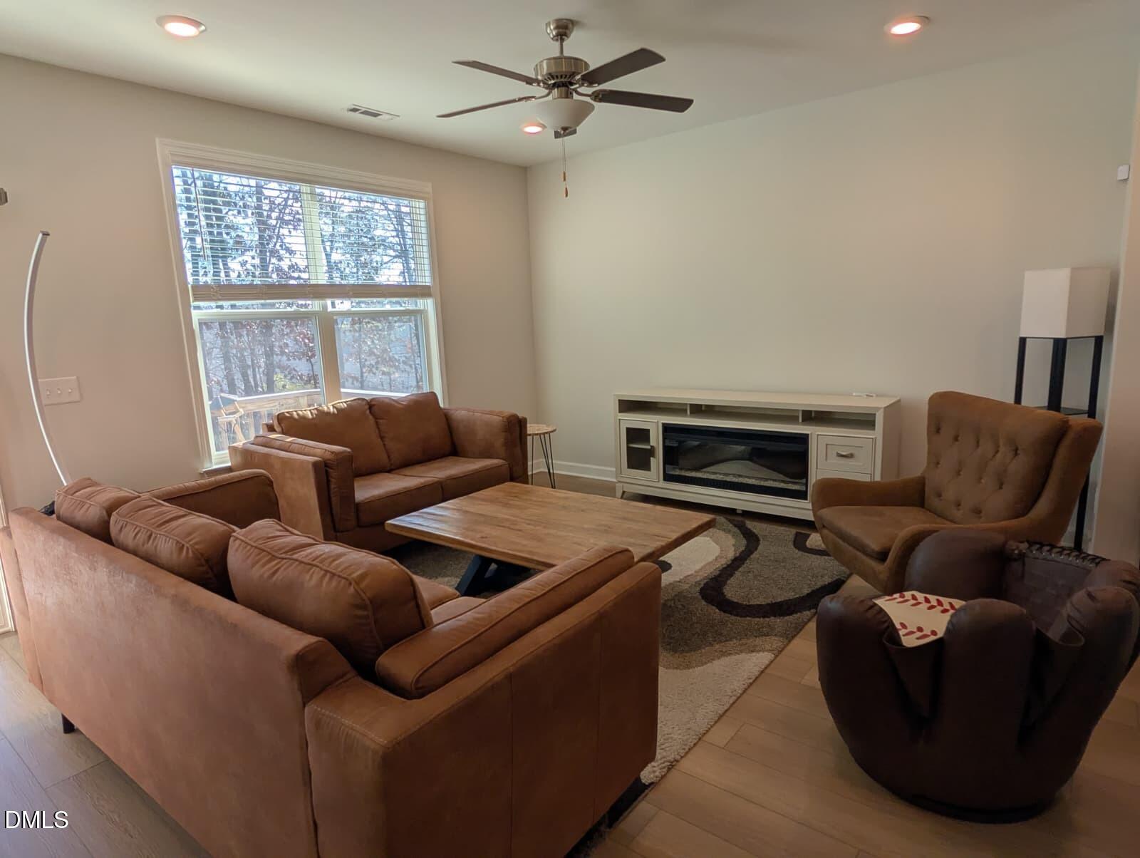 230 George Pine Way Knightdale, NC 27545 - Photo 4 of 31 a living room with furniture a flat screen tv and a window