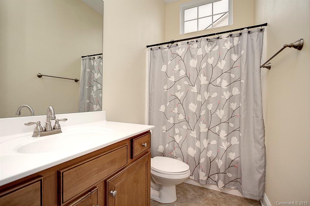 907 Treasure Court Fort Mill, SC 29708 - Photo 22 of 31 a bathroom with a sink and a mirror