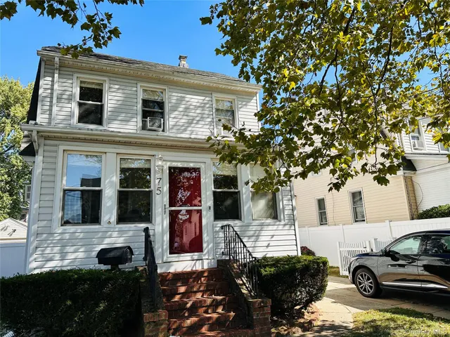 a front view of a house with parking space