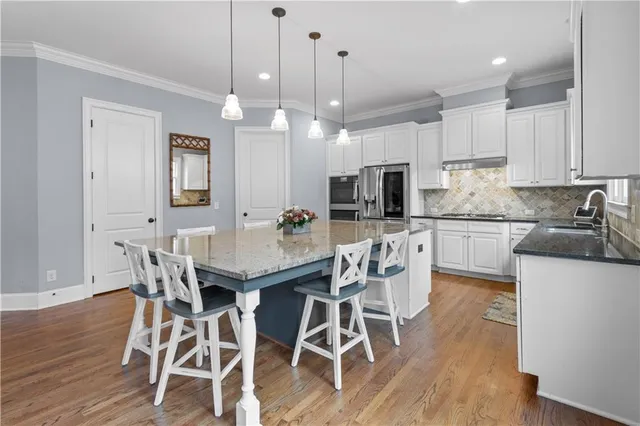 a bathroom with a granite countertop sink toilet mirror and shower