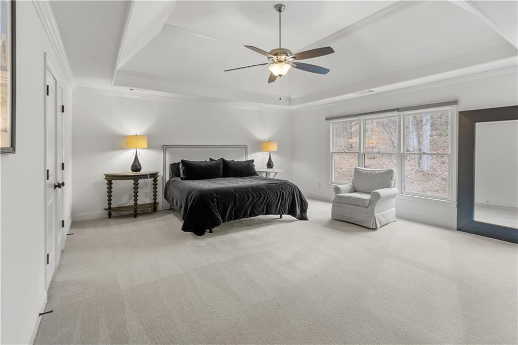 1625 Hamiota Ridge Alpharetta, GA 30004 - Photo 38 of 86 a bedroom with furniture and a chandelier