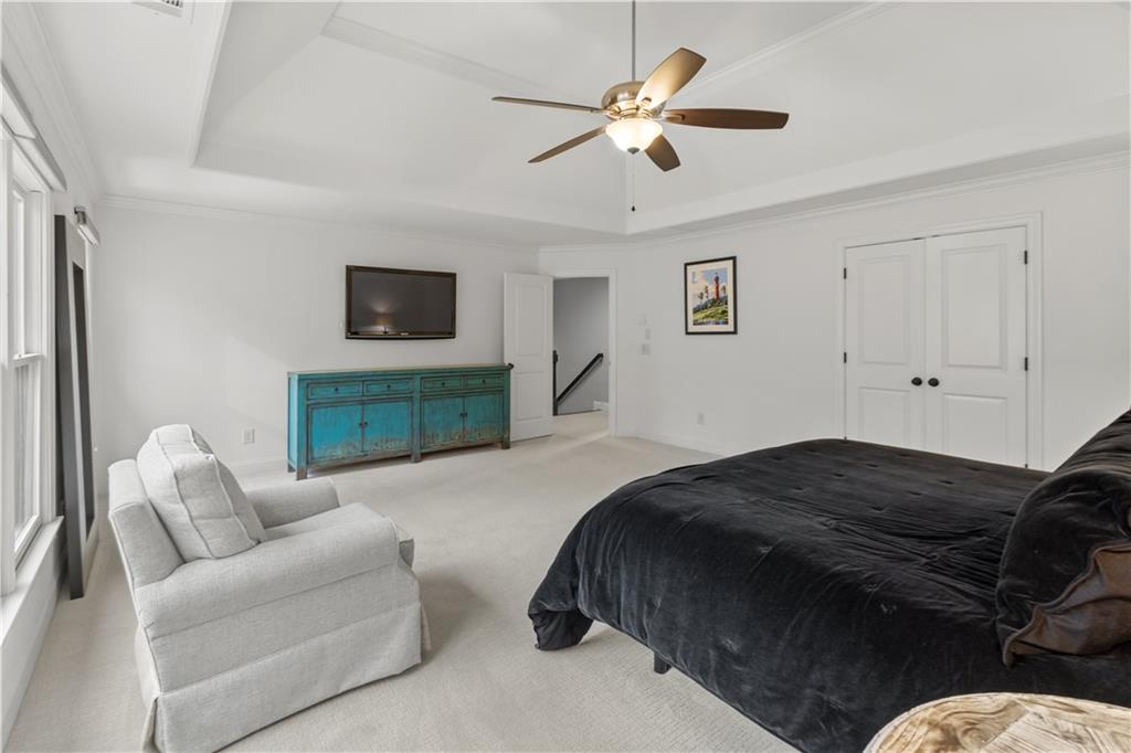 1625 Hamiota Ridge Alpharetta, GA 30004 - Photo 39 of 86 a spacious bedroom with a bed a couch and a ceiling fan