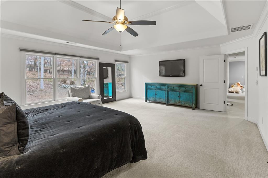 1625 Hamiota Ridge Alpharetta, GA 30004 - Photo 40 of 86 a spacious bedroom with a large bed and a large window