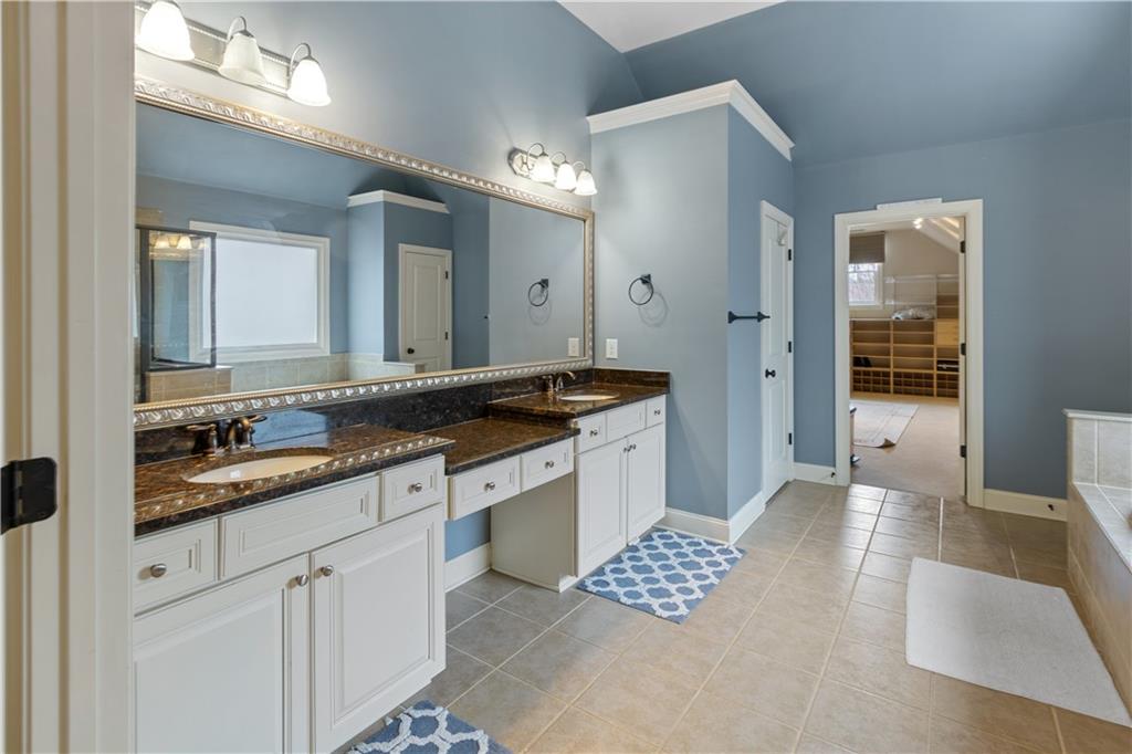 1625 Hamiota Ridge Alpharetta, GA 30004 - Photo 41 of 86 a spacious bathroom with a double vanity sink a mirror and a shower