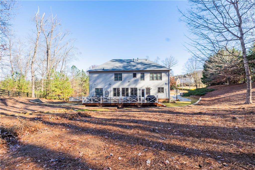1625 Hamiota Ridge Alpharetta, GA 30004 - Photo 5 of 86 a front view of a house with a yard and dining table and chairs
