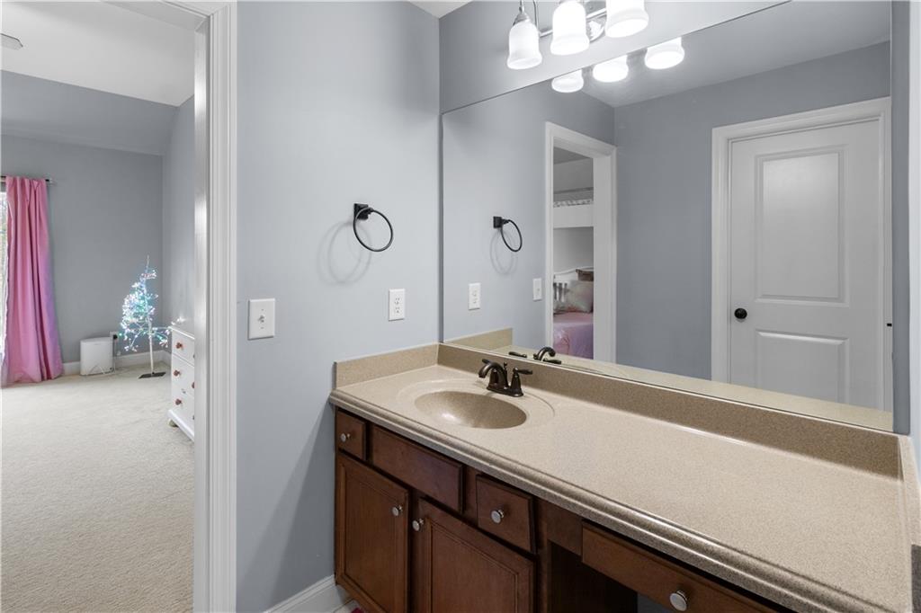 1625 Hamiota Ridge Alpharetta, GA 30004 - Photo 52 of 86 a bathroom with a sink a light fixture and a mirror