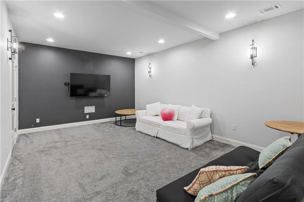 1625 Hamiota Ridge Alpharetta, GA 30004 - Photo 59 of 86 a living room with furniture and a flat screen tv
