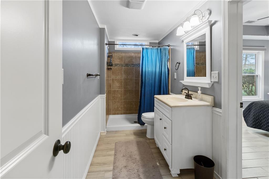 1625 Hamiota Ridge Alpharetta, GA 30004 - Photo 62 of 86 a bathroom with a sink a mirror and a shower