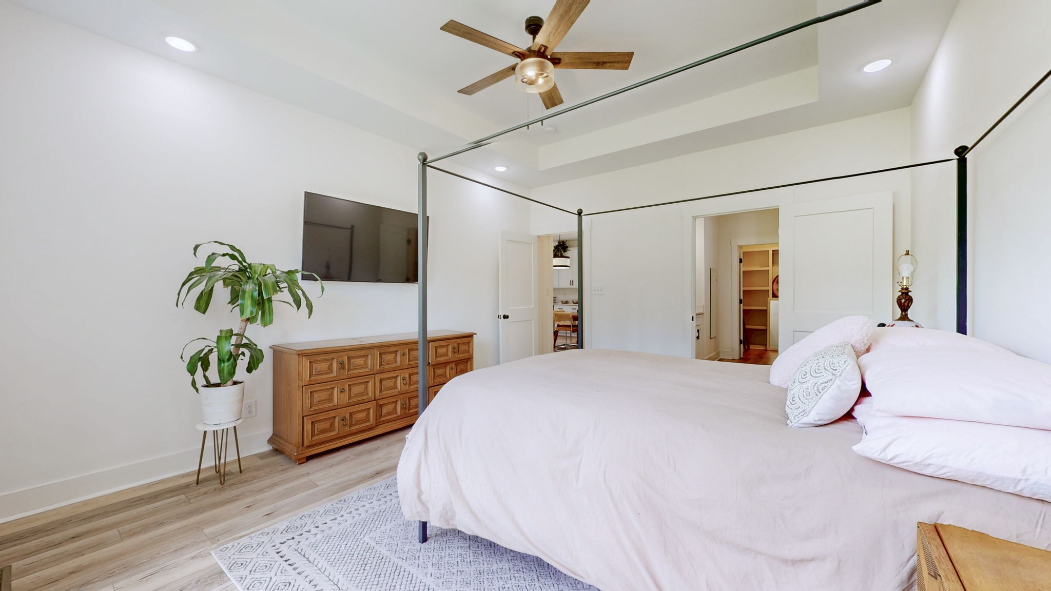 1663 Taylortown Road White Bluff, TN 37187 - Photo 3 of 38 a bedroom with a bed a flat screen tv and a potted plant