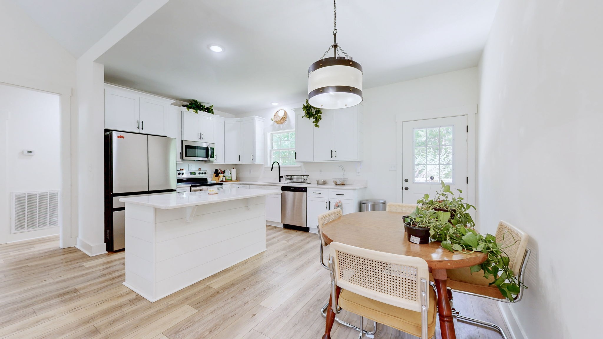1663 Taylortown Road White Bluff, TN 37187 - Photo 6 of 38 a kitchen with white cabinets and stainless steel appliances