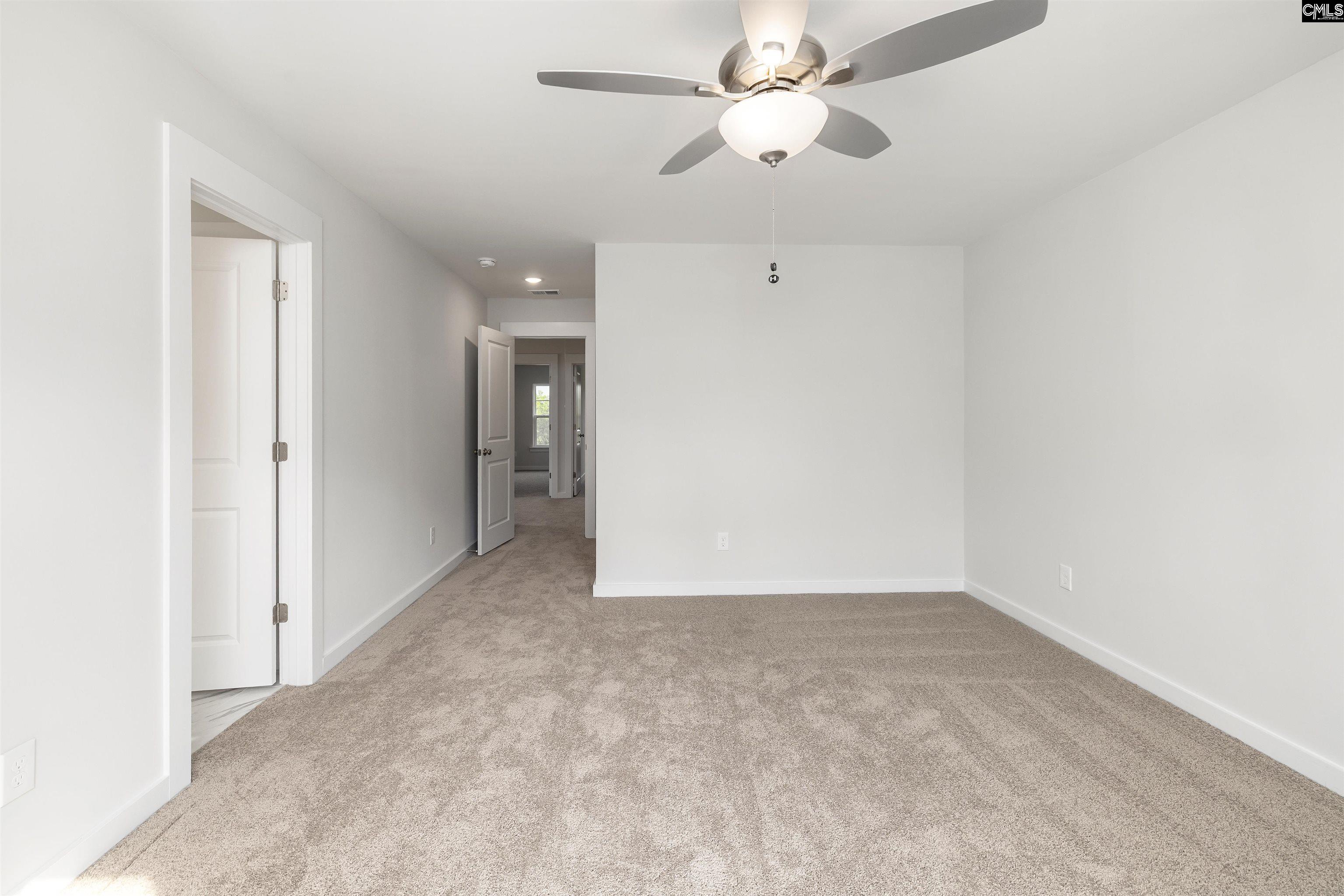 32 Fawn Spot Court Elgin, SC 29045 - Photo 17 of 28 an empty room with a ceiling fan and a window