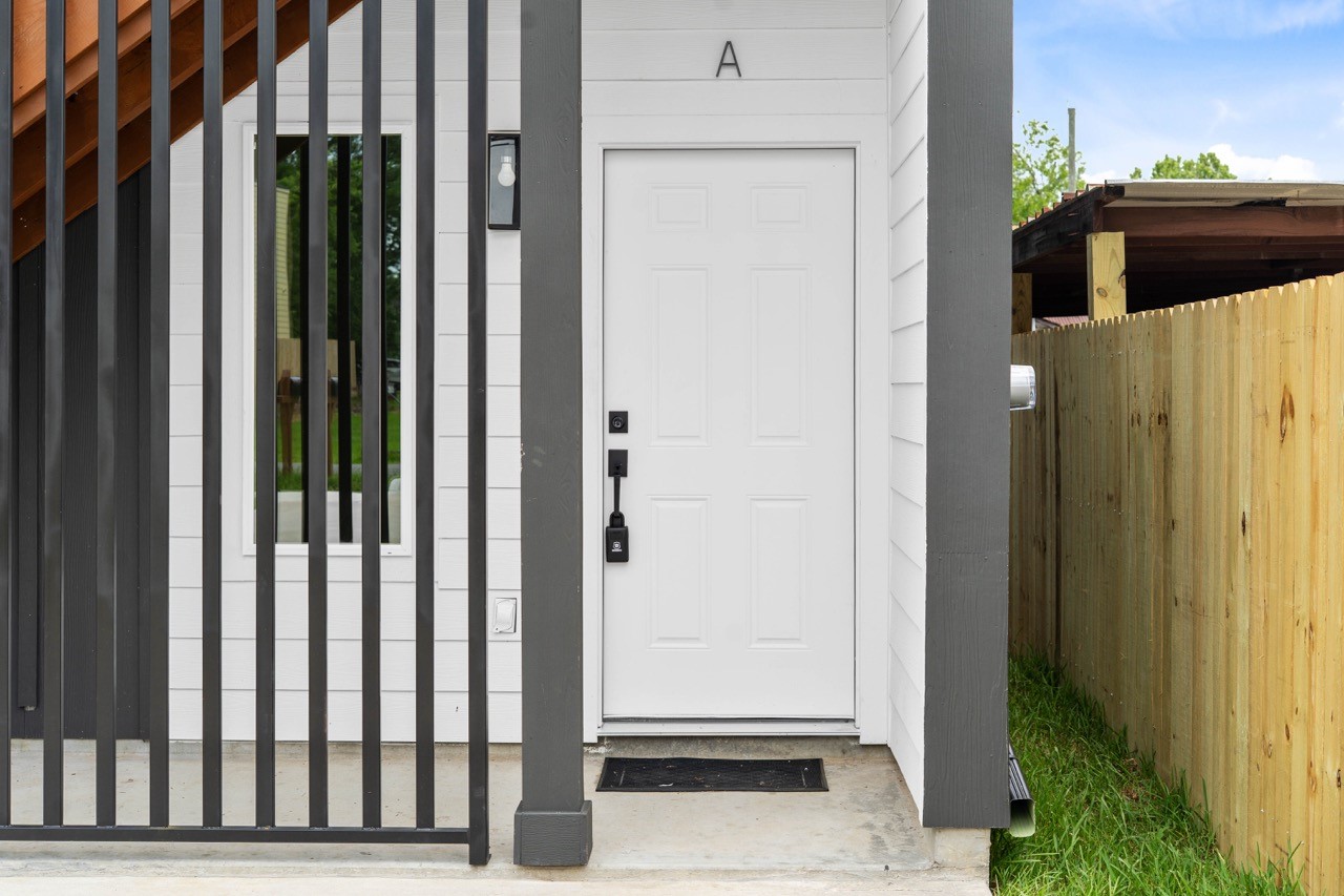 9725 Kerr Street, Unit A Houston, TX 77029 - Photo 3 of 34 Close-up of the private front door and gated entry, showing the secure, well-defined access point and crisp exterior details for this modern rental unit.