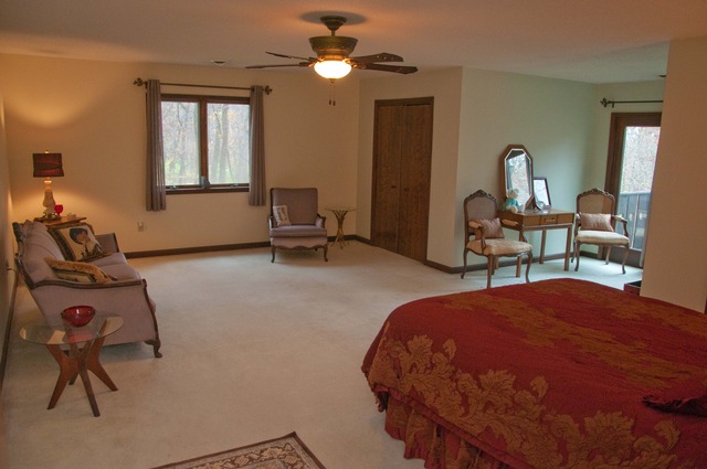7271 South Ridge Road Dixon, IL 61021 - Photo 7 of 18 a bedroom with a bed and a chandelier