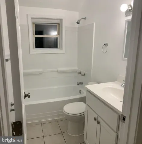 a white toilet sitting next to a shower