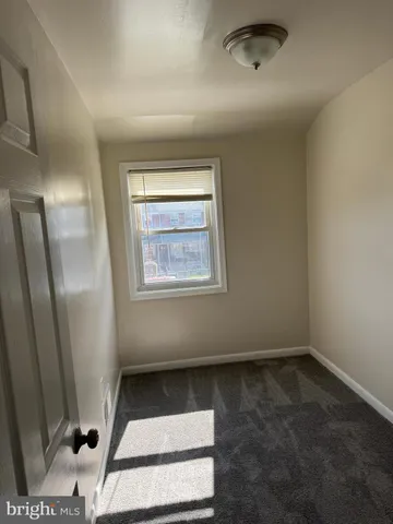 a view of a hallway with wooden floor and door