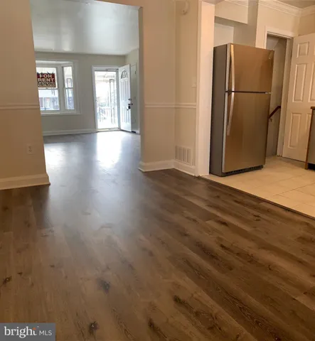 a kitchen with stainless steel appliances granite countertop a refrigerator stove and sink