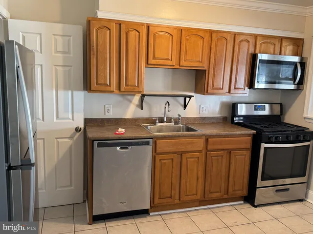 a view of a kitchen from a hallway