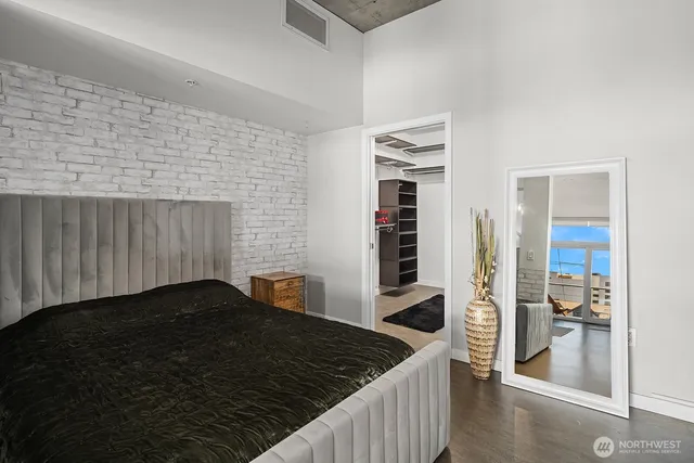 a bedroom with a bed and a view of living room