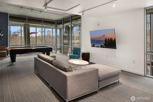a living room with stainless steel appliances kitchen island granite countertop furniture and a large window