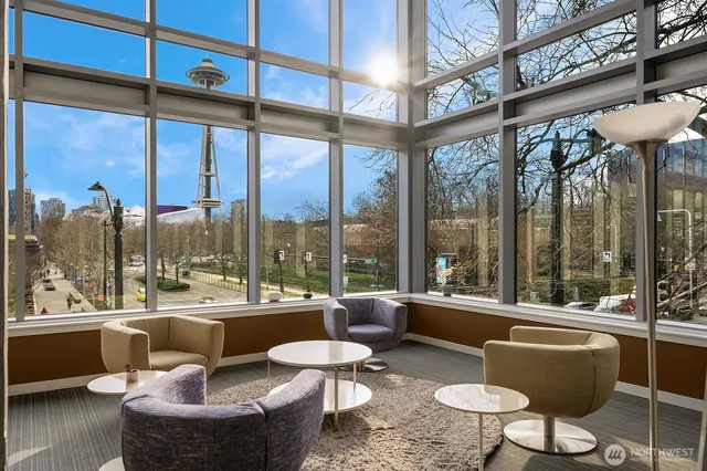 a living room with patio furniture and a floor to ceiling window